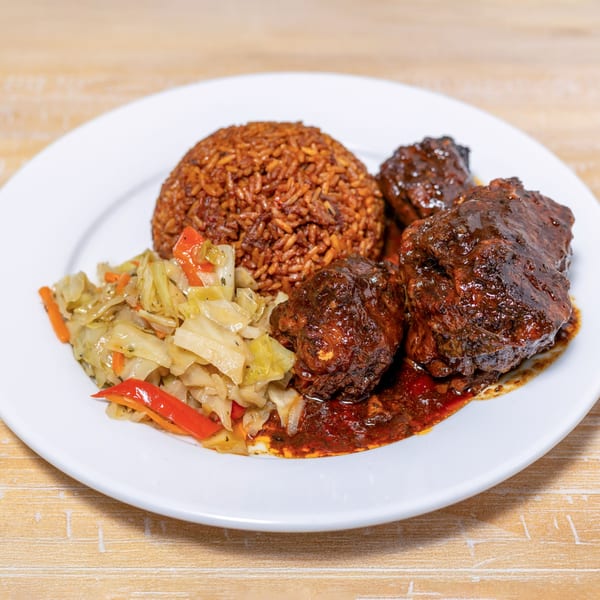Cubana Grille's Caribbean dish with brown rice, stewed cabbage, and dark meat in sauce.